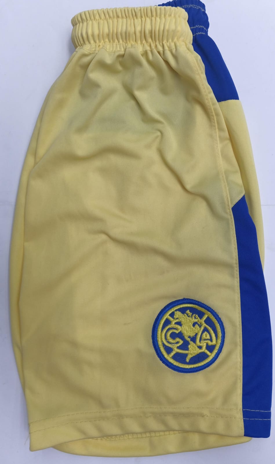 Short Niño America Amarillo